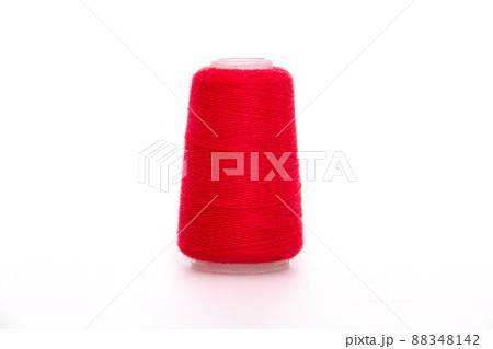 Red spool of thread isolated on white background. Skein of woolen threads. Yarn for knitting. Materials for sewing machine. Coil. 88348142