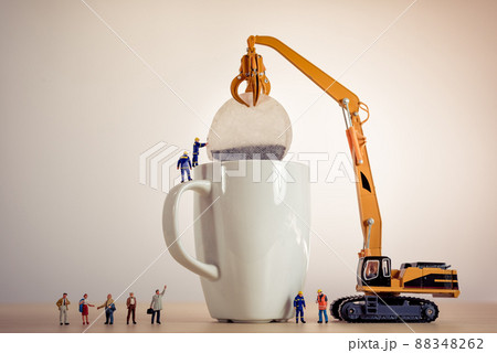 Miniature guys making tea 88348262