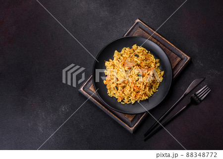 Pilaf or pilau with chicken, traditional uzbek hot dish of boiled rice, chicken meat, vegetables and spices 88348772