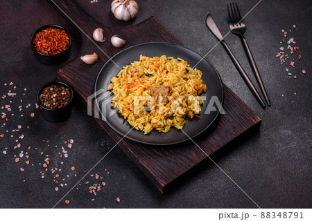 Pilaf or pilau with chicken, traditional uzbek hot dish of boiled rice, chicken meat, vegetables and spices 88348791