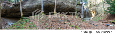 A natural amphiheatre with rock walls and waterfalls in the midst of a forest 88348997