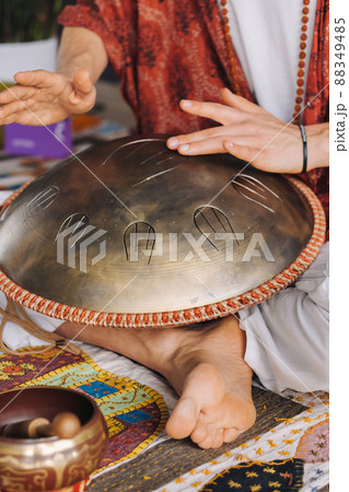 Close-up of a man's hand playing a modern musical instrument, the orion reed drum 88349485