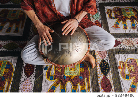 Close-up of a man's hand playing a modern musical instrument, the orion reed drum 88349486