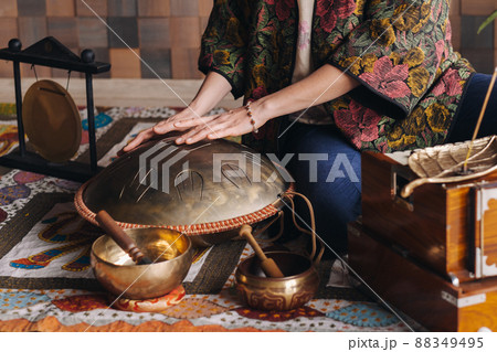 Close-up of a woman's hand playing a modern musical instrument - the Orion reed drum 88349495