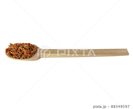 dried carrot pieces on wooden spoon isolated on white background. Spices and food ingredients. dried carrot pieces on wooden spoon isolated on white background. Spices and food ingredients. 88349597