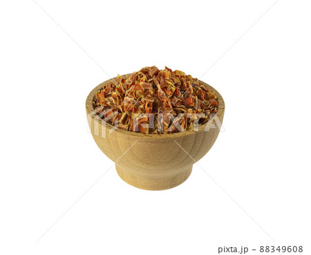 dried carrot pieces in wooden bowl isolated on white background. Spices and food ingredients. 88349608