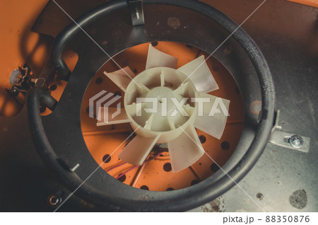 The internal device of the electric dryer for the dehydration of vegetables and fruits. Repair of household equipment. Selective focus The internal device of the electric dryer for the dehydration of vegetables and fruits. Repair of household equipment. Selective focus 88350876