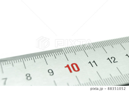Iron ruler close-up on a white background. Stainless steel ruler. Working tools made of metal and stationery. Selective focus, isolated on white Iron ruler close-up on a white background. Stainless steel ruler. Working tools made of metal and stationery. Selective focus, isolated on white 88351052
