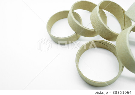 Narrow cardboard spools for winding rolled materials and self-adhesive labels. Reels made of cardboard for printing houses. Selective focus, isolated on white Narrow cardboard spools for winding rolled materials and self-adhesive labels. Reels made of cardboard for printing houses. Selective focus, isolated on white 88351064