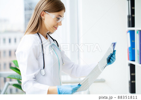 Doctor check up x-ray film of the brain by ct scan brain at patient room hospital. 88351811