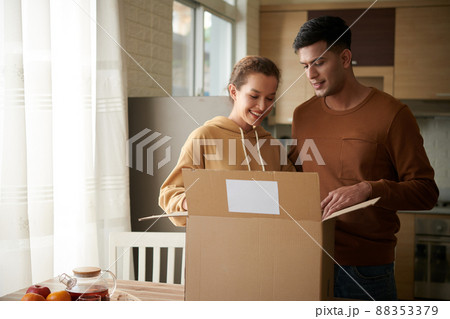 Couple Opening Box With Belongings 88353379
