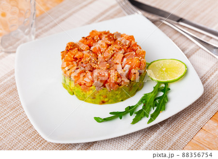 Raw salmon tartare with guacamole and sesame Raw salmon tartare with guacamole and sesame 88356754