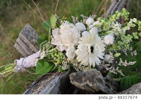 Bouquet of Assorted White Flowers Including Gerber Daisies, Roses, Peonies on Split Rail Fence 88357674