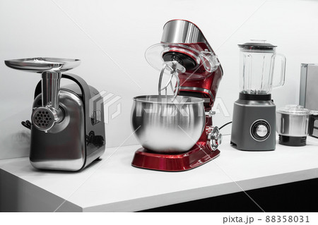Kitchen electrical appliances and equipment, new small household appliances. Meat grinder, planetary mixer and blender on the table Kitchen electrical appliances and equipment, new small household appliances. Meat grinder, planetary mixer and blender on the table 88358031
