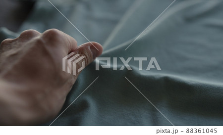 man hand touching blue cotton fabric man hand touching blue cotton fabric 88361045