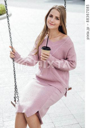 blonde woman with a drink of coffee or cocktail blonde woman with a drink of coffee or cocktail 88367085