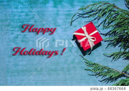 Gift box, coniferous branches and greeting on neon blue and green background 88367668
