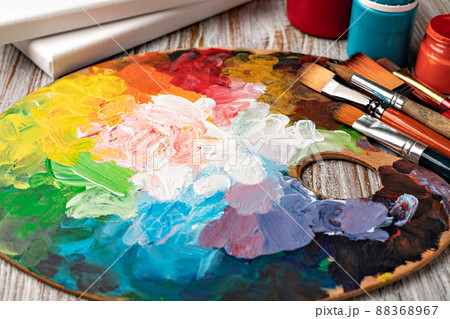 art palette with colorful mixed paints 88368967