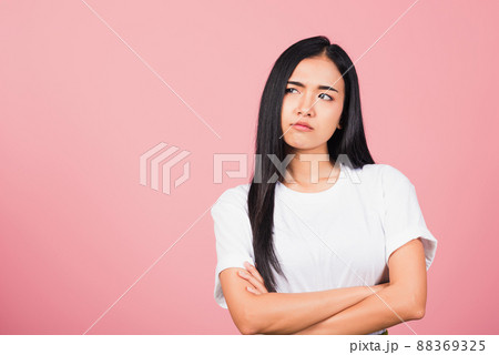 woman standing with crossed arms angry and mad raising fist frustrated woman standing with crossed arms angry and mad raising fist frustrated 88369325
