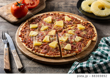 Hawaiian pizza with pineapple,ham and cheese Hawaiian pizza with pineapple,ham and cheese 88369892