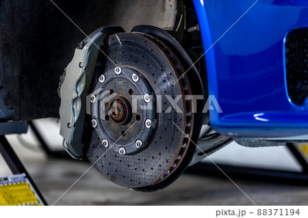Close up of a modern car brakes during maintenance repair, transport concept Close up of a modern car brakes during maintenance repair, transport concept 88371194