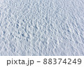 Relief snow surface of a frozen river in winter 88374249
