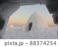 View from an igloo to another igloo  at sunset 88374254