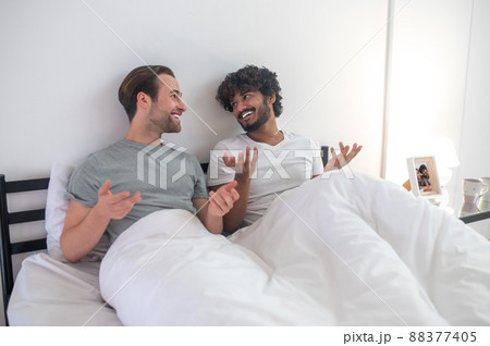 Gay couple talking to each other in their bedroom 88377405