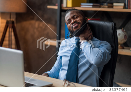Overworked company employee suffering from a cervical pain 88377465