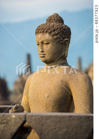 Side portrait of buddha statue at buddhist temple Borobudur, Java, Indonesia Side portrait of buddha statue at buddhist temple Borobudur, Java, Indonesia 88377923