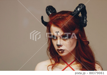 Beautiful young woman with makeup zodiac signs of Capricorn or Aries or Taurus. Girl with horns on head. 88379061