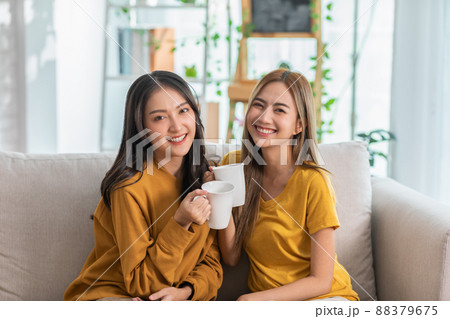Young beautiful Asian lesbian couple smiling to each other Young beautiful Asian lesbian couple smiling to each other 88379675