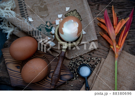 Boiled eggs with salt and pepper on beautiful wooden background, Nutrition concept. 88380696