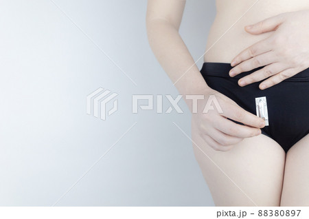 Vaginal or rectal candle in the hands of a woman against the background of the abdomen and underwear. Treatment vaginal infections, candidiasis, thrush and sexually transmitted infections Vaginal or rectal candle in the hands of a woman against the background of the abdomen and underwear. Treatment vaginal infections, candidiasis, thrush and sexually transmitted infections 88380897