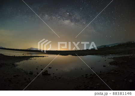 The stars in the sky reflect the light at night. The Milky Way above the mountains and the pond Mae Prachan Dam and Reservoir, Phetchaburi, Thailand The stars in the sky reflect the light at night. The Milky Way above the mountains and the pond Mae Prachan Dam and Reservoir, Phetchaburi, Thailand 88381146