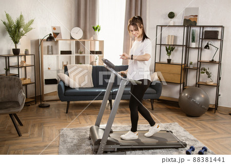 Tone your body. Perfect shape. Improving endurance. Portrait of young sportive woman doing cardio Tone your body. Perfect shape. Improving endurance. Portrait of young sportive woman doing cardio 88381441