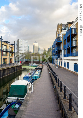 Limehouse, London, UK: Boats moored on a canal near Limehouse Basin, a marina in the docklands area of eastern London. Apartments to the side and Canary Wharf behind. 88382184