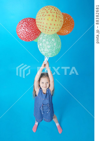 Girl holds balloons Girl holds balloons 88382681