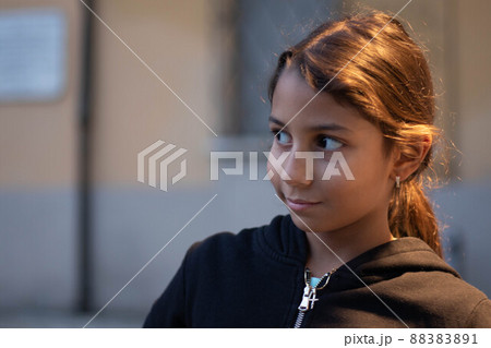 Happy brunette girl portrait with unfocused background Happy brunette girl portrait with unfocused background 88383891