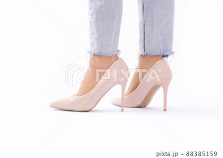 Slender female legs in patent leather shoes with high heels. Light blue ripped jeans. Fashion and Style. Side view Slender female legs in patent leather shoes with high heels. Light blue ripped jeans. Fashion and Style. Side view 88385159