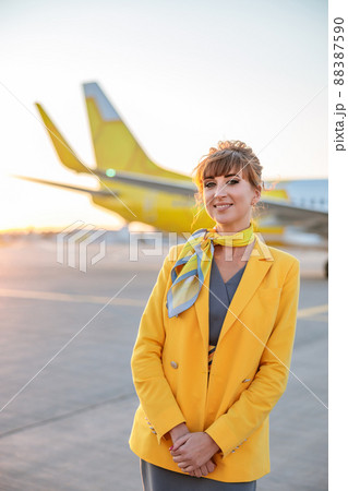 Joyful woman stewardess standing outdoors at airport 88387590
