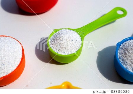 Detergent powder with measuring spoon for clothes washing. Laundry concept. 88389086