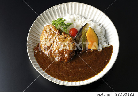 野菜の煮浸しとパセリ添えの粗びきハンバーグカレーを黒背景で俯瞰撮影 野菜の煮浸しとパセリ添えの粗びきハンバーグカレーを黒背景で俯瞰撮影 88390132