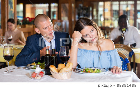 Unhappy couple quarreling during dinner at restaurant 88391488