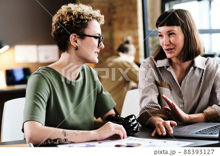 Girl with disability having business interview with businesswoman at the table with laptop Girl with disability having business interview with businesswoman at the table with laptop 88393127