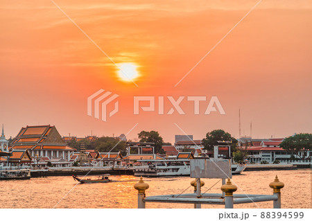 Sun Setting in Bangkok's Chao Phraya river with Buddishm temple with dramatic sky. Sun Setting in Bangkok's Chao Phraya river with Buddishm temple with dramatic sky. 88394599
