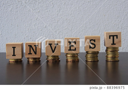 Coins Stack with Invest text on wooden blocks - Business and Financial Concept 88396975