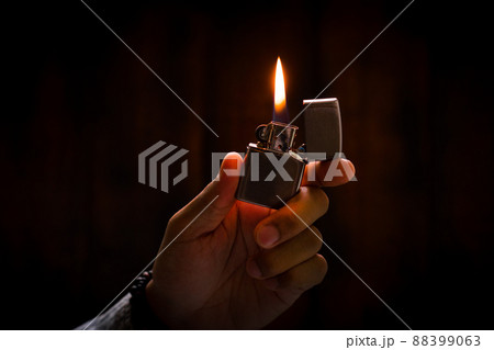 metal lighter in man's hand 88399063