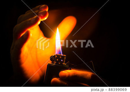 metal lighter in man's hand 88399069