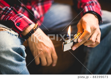 metal lighter in man's hand 88399073